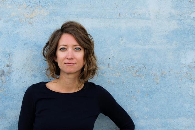 Portrait of Stephanie Evergreen on a pale blue background